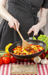Housewife cooking mexican style dish