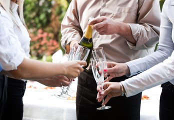 young  business people having a toast with champaing