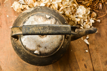 Old kettle on old wooden table