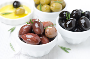 black, green and kalamata olives in a bowl close-up