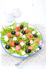salad with watermelon, feta cheese and olives on the plate