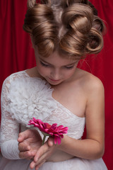 closeup of little girl model with gerbera flower. 