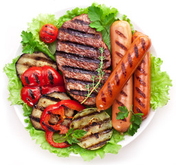 Grilled steak,sausages and vegetables.