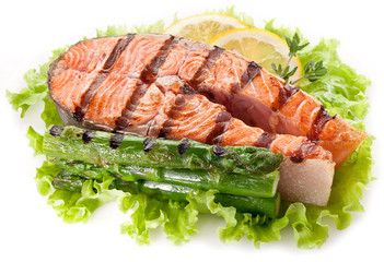 Grilled salmon and asparagus on a white background.