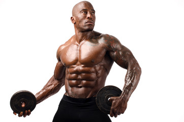 Black bodybuilder posing with round discs