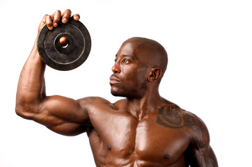 Black bodybuilder posing with round discs