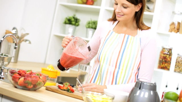 Caucasian Girl Pouring Healthy Homemade Fruit Smoothie