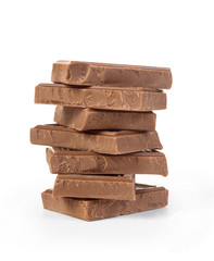 Stack of chocolate pieces on a white background