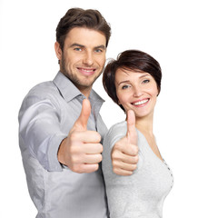 Portrait of happy couple with thumbs up sign