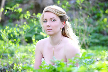 beautiful girl in wood amongst green sheet