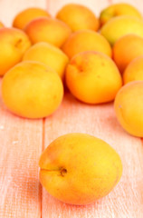 Naklejka na ściany i meble Fresh natural apricot on wooden table