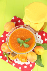 Apricot jam in glass jar and fresh apricots,