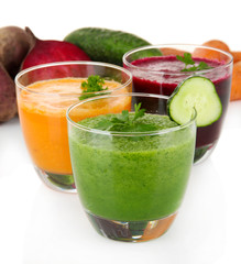 Fresh vegetable juices isolated on white