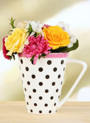 Fototapeta na wymiar Beautiful bouquet of bright flowers in color mug,