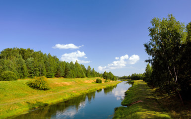 Obraz premium Summer landscape with a river and grass on the coast