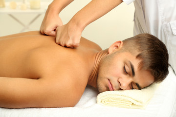 Young man having back massage close up