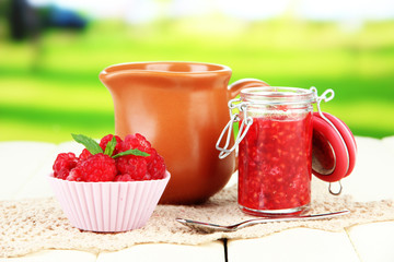 Fresh raspberry, raspberry jam and cream in jug