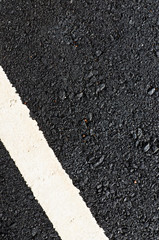 Closeup new asphalt road with white line