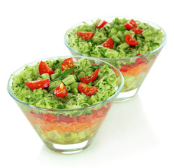 Tasty salad with fresh vegetables, isolated on white