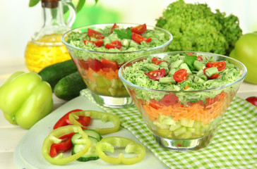 Tasty salad with fresh vegetables on wooden table