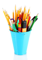 Colorful pencils and other art supplies in pail isolated