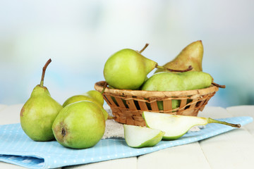 Pears in  wicker basket, on light background