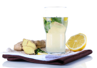 Glass of cold tea with ginger on napkin isolated on white