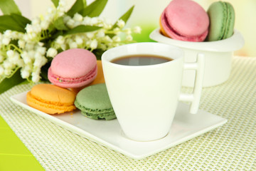 Coffee and macaroons on table close-up