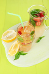 Basil lemonade with strawberry in  jug and glass,