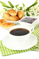 Tasty croissants and cup of coffee close-up