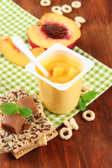 Tasty yogurt with pieces of fresh fruits, cookies and flakes,on