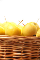 yellow apples in a wicker basket