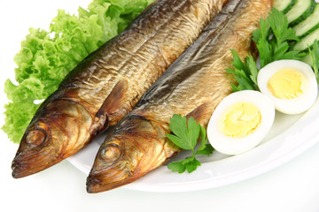 Smoked fish on plate close up