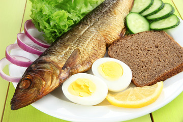 Smoked fish on plate close up
