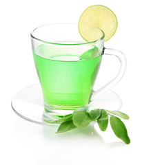 Transparent cup of green tea with sage and lime isolated