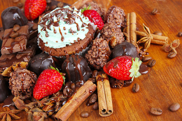Tasty cupcake with different sweets close up