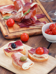 sliced prosciutto with olive cheese and Cherry tomato