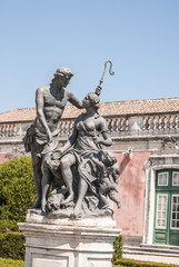 Fototapeta na wymiar Antique statue in park of Queluz