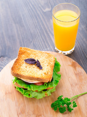 Sandwich with ham, cheese, tomatoes and lettuce