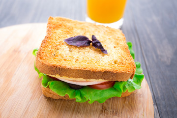 Sandwich with ham, cheese, tomatoes and lettuce