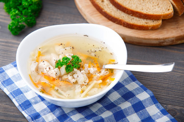 Bowl of chicken soup with vegetables and noodles