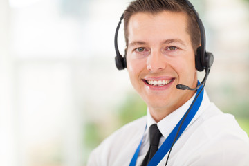 male call centre employee wearing a headset
