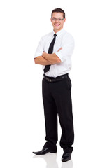 young businessman standing with arms crossed