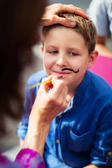 Cute boy with painted mustache