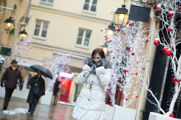 Fototapeta na wymiar Girl walking on a street decorated for Christmas