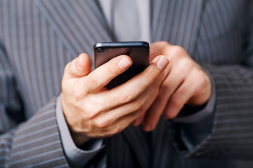 Cropped view of Businessman holding the phone