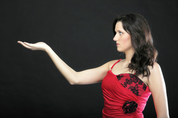 Portrait woman in red corset with empty hand- copyspace