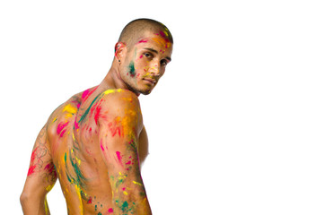 Handsome young man with skin painted with colors