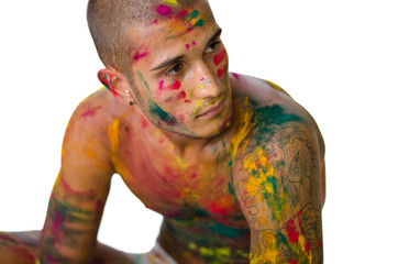 Attractive young man shirtless, skin painted with Honi colors