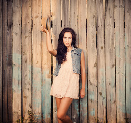 Fototapeta premium young beautiful girl on wooden wall